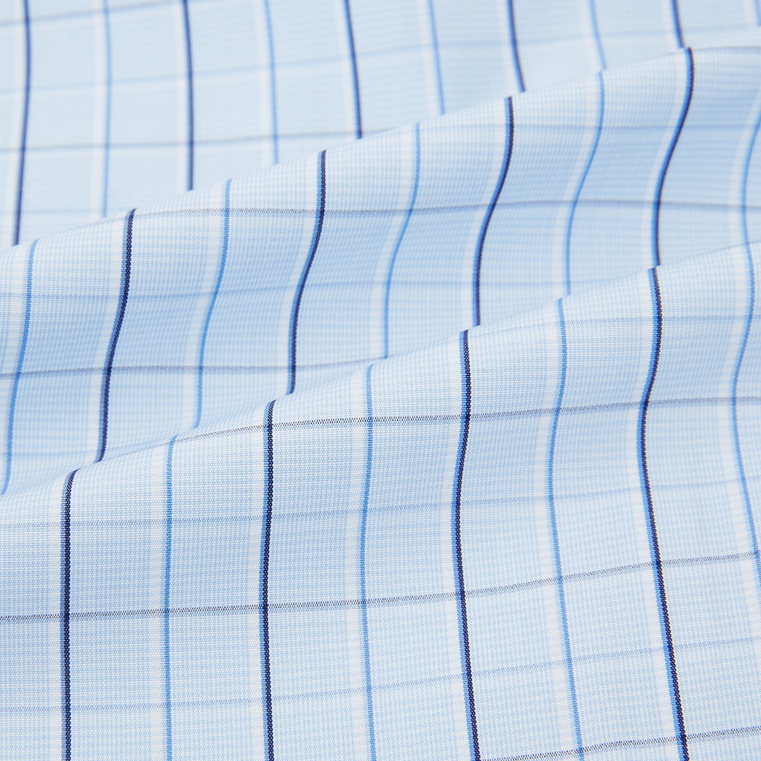 View 6 of product The Navy and Blue Combination Check Mayfair Shirt by Turnbull & Asser features a light blue base with a grid of thin dark blue lines, long sleeves, a pointed collar, and is neatly displayed on a plain white background.