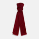The Burgundy Cashmere Scarf by Turnbull & Asser features a soft texture, deep red hue, and lightly frayed edges, loosely knotted and displayed on a plain white background—an elegant luxury accessory.