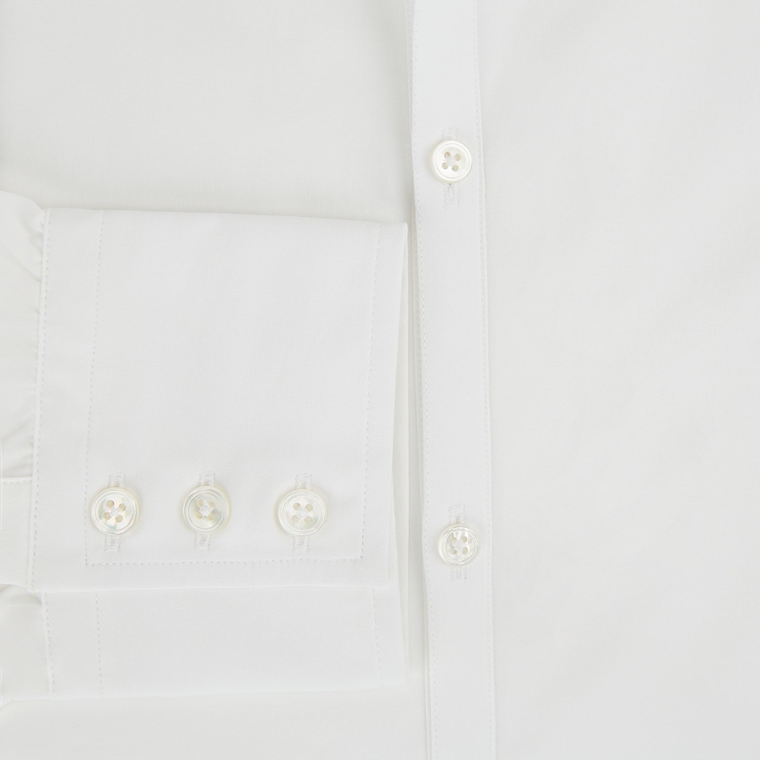 View 4 of product The Turnbull & Asser Plain White Windsor Shirt features a Turnbull open collar, 3-button cuffs, and relaxed fit—exemplifying British craftsmanship. Displayed on a white background.