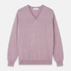 View 1 of product The Turnbull & Asser Lilac Heather Paden Cashmere V-Neck Jumper is laid flat on a white background, showcasing its light purple hue, ribbed cuffs and hem, long sleeves, and soft heathered texture.