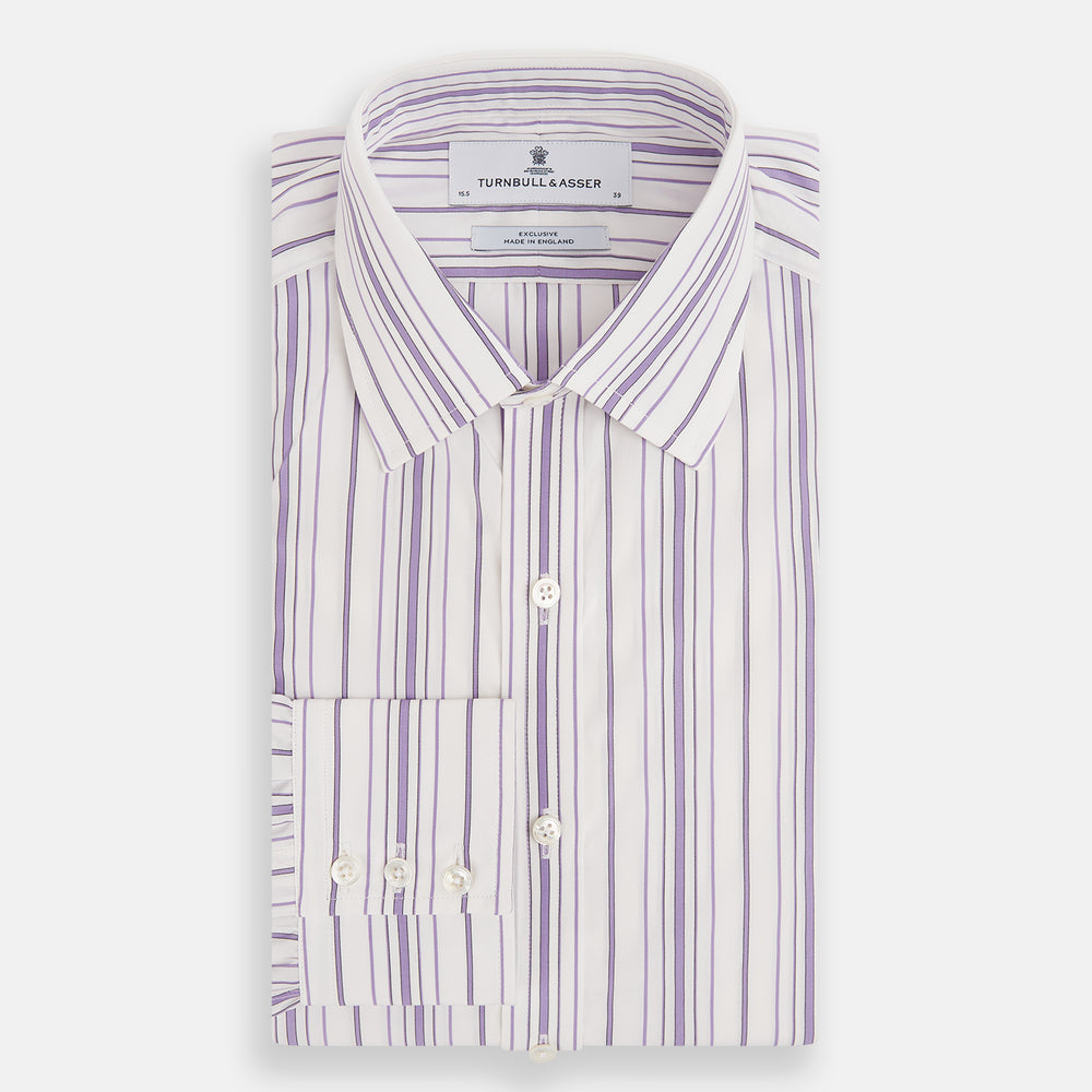 The Purple Multi Stripe Mayfair Shirt by Turnbull & Asser is a long-sleeve, collared button-up featuring vertical blue and purple stripes on white, ideal for formal occasions. The shirt is neatly displayed flat against a white background.