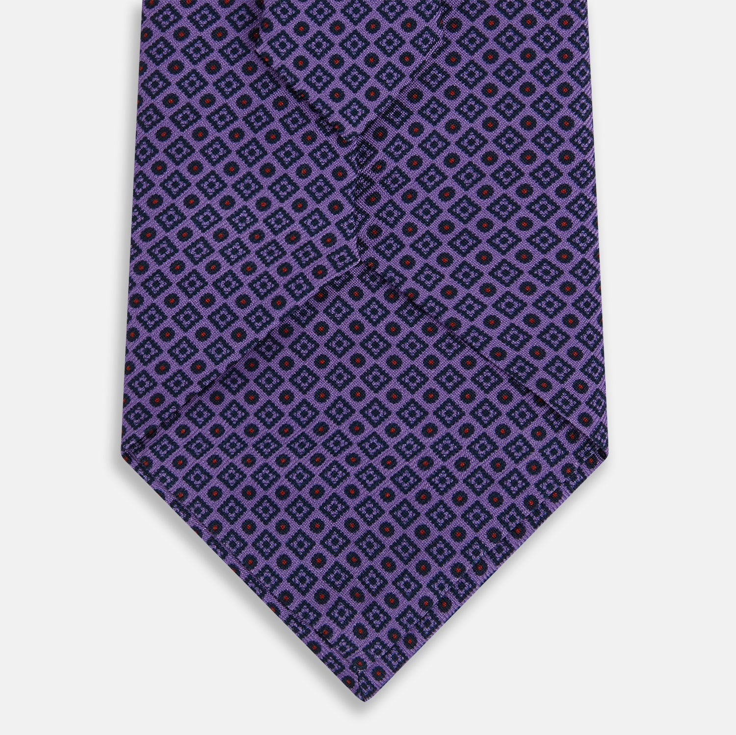 View 3 of product The Turnbull & Asser Purple Square and Circle Silk Tie is crafted from fine English silk, showcasing a purple design with a repeating geometric pattern of squares and circles for a refined, elegant look.