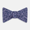 View 1 of product The Turnbull & Asser Lilac Paisley Silk Bow Tie features a refined dark blue pattern on lilac silk, shown on a plain white background—an elegant men's accessory for any occasion.