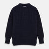 View 1 of product The Turnbull & Asser Navy Wool and Cotton Blend Albany Guernsey Jumper, shown flat on a white background, features long sleeves, a classic cable knit pattern on the upper half, and ribbed cuffs, hem, and collar.