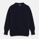 The Turnbull & Asser Navy Wool and Cotton Blend Albany Guernsey Jumper, shown flat on a white background, features long sleeves, a classic cable knit pattern on the upper half, and ribbed cuffs, hem, and collar.