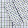 View 3 of product The Turnbull & Asser Green and Blue Check Cotton Hyde Pyjama Set for men features a long-sleeve, button-up top and pants with contrasting dark piping, shown laid flat on a white background.