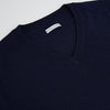 View 2 of product The Turnbull & Asser Navy Fine Merino V-Neck Jumper is displayed against a white background, featuring ribbed cuffs and hem for timeless style in a classic, plain long-sleeve design.