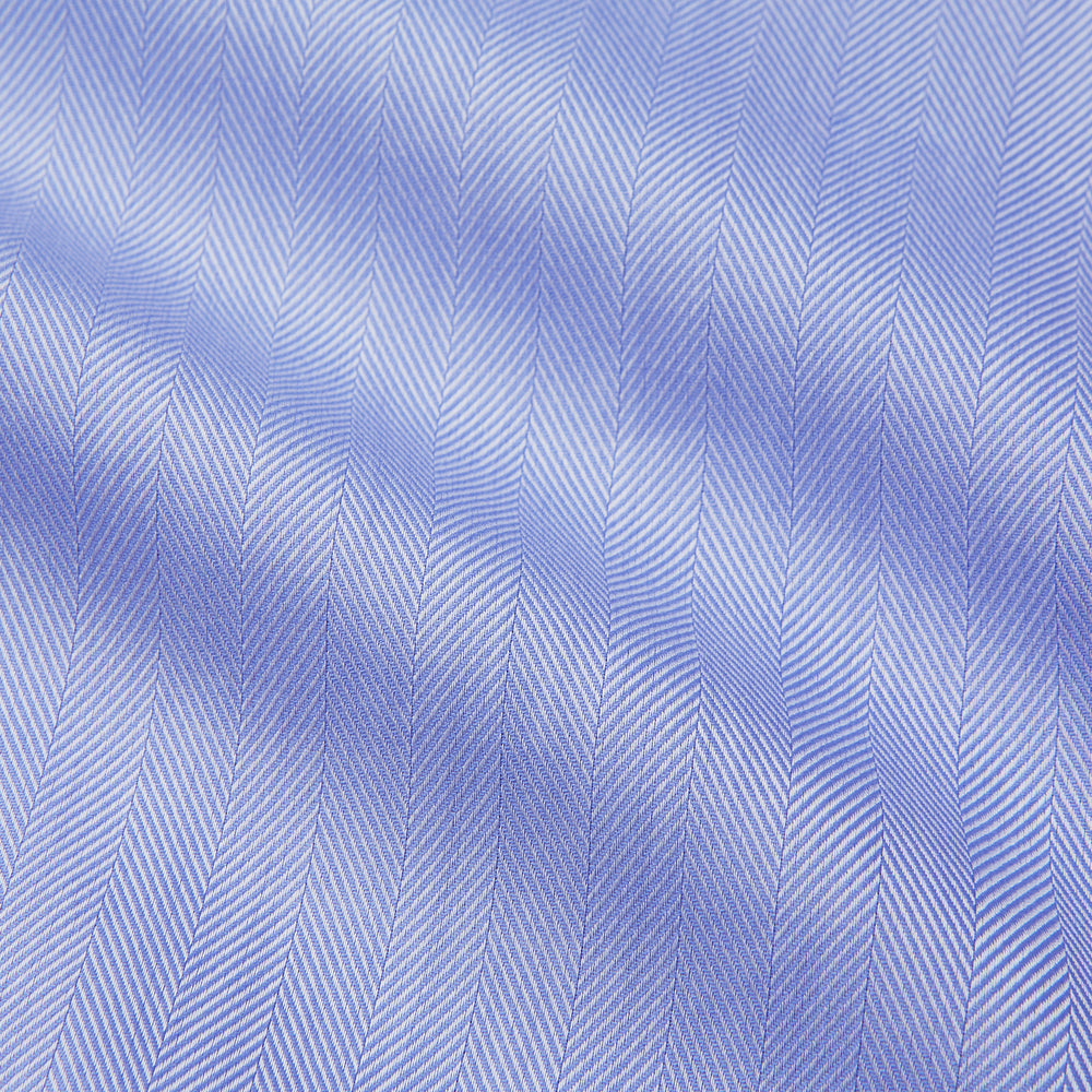The Turnbull & Asser Blue Herringbone Regular Fit Shirt features a classic Kent collar, long sleeves, white buttons, and buttoned cuffs. Displayed on a white background, it's the perfect formal shirt for any occasion.