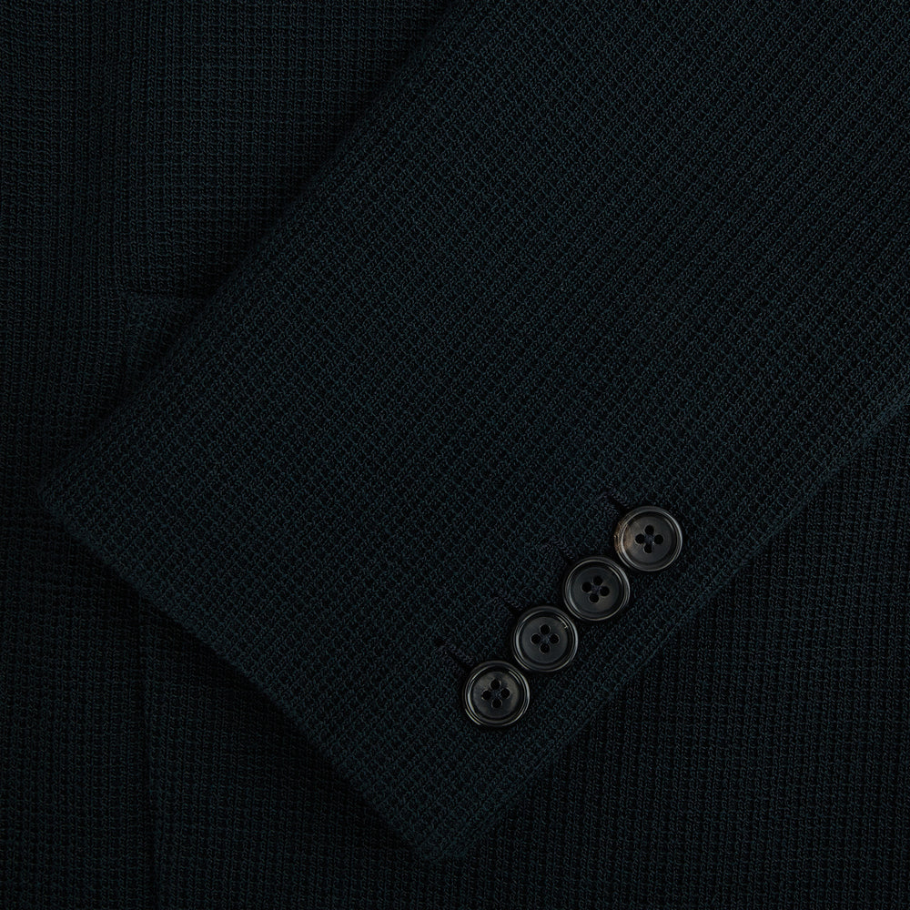 The Forest Green KNITTED CAMBRIDGE BLAZER by Turnbull & Asser, crafted from textured Italian wool with notch lapels, patch and chest pockets, and two buttons, is shown against a plain white background.