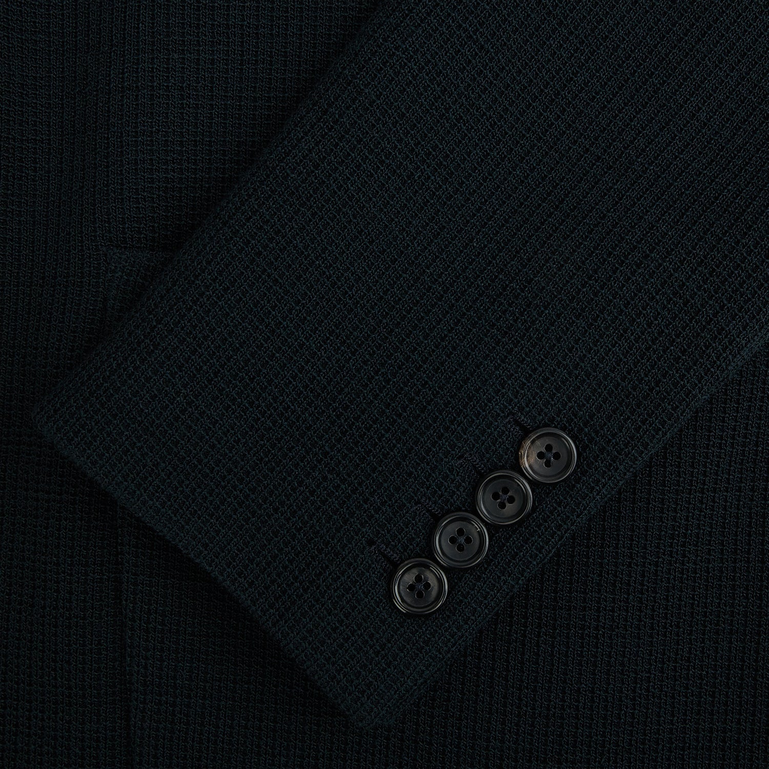 View 4 of product The Forest Green KNITTED CAMBRIDGE BLAZER by Turnbull & Asser, crafted from textured Italian wool with notch lapels, patch and chest pockets, and two buttons, is shown against a plain white background.