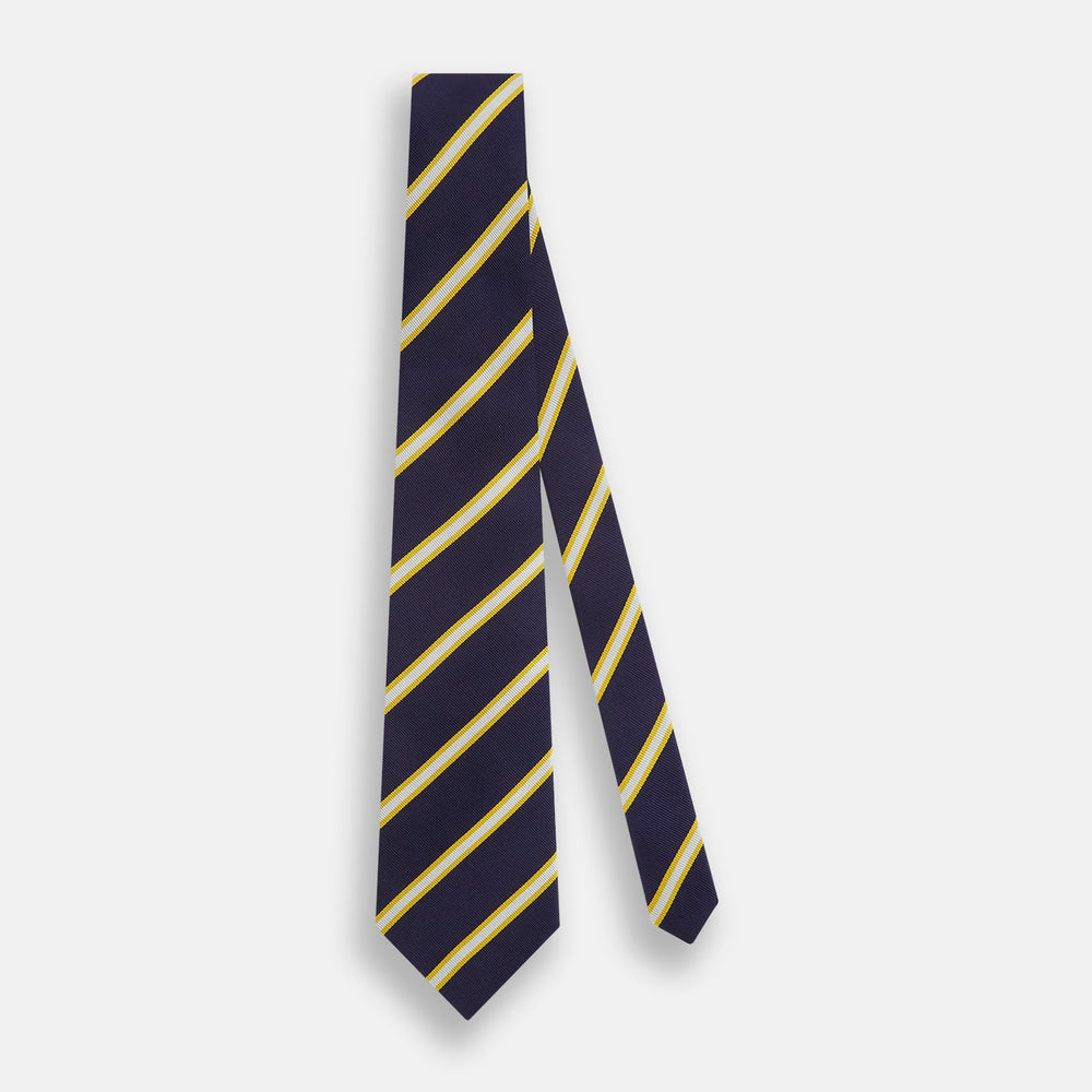 The Turnbull & Asser White and Navy Blazer Silk Tie, featuring diagonal yellow and white stripes, is rolled up neatly on a light gray background.
