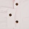 View 4 of product The Soft Pink Hyde Overshirt by Turnbull & Asser features long sleeves, sanforised cotton, dark buttons, and a left front pocket, shown laid flat on a white background.