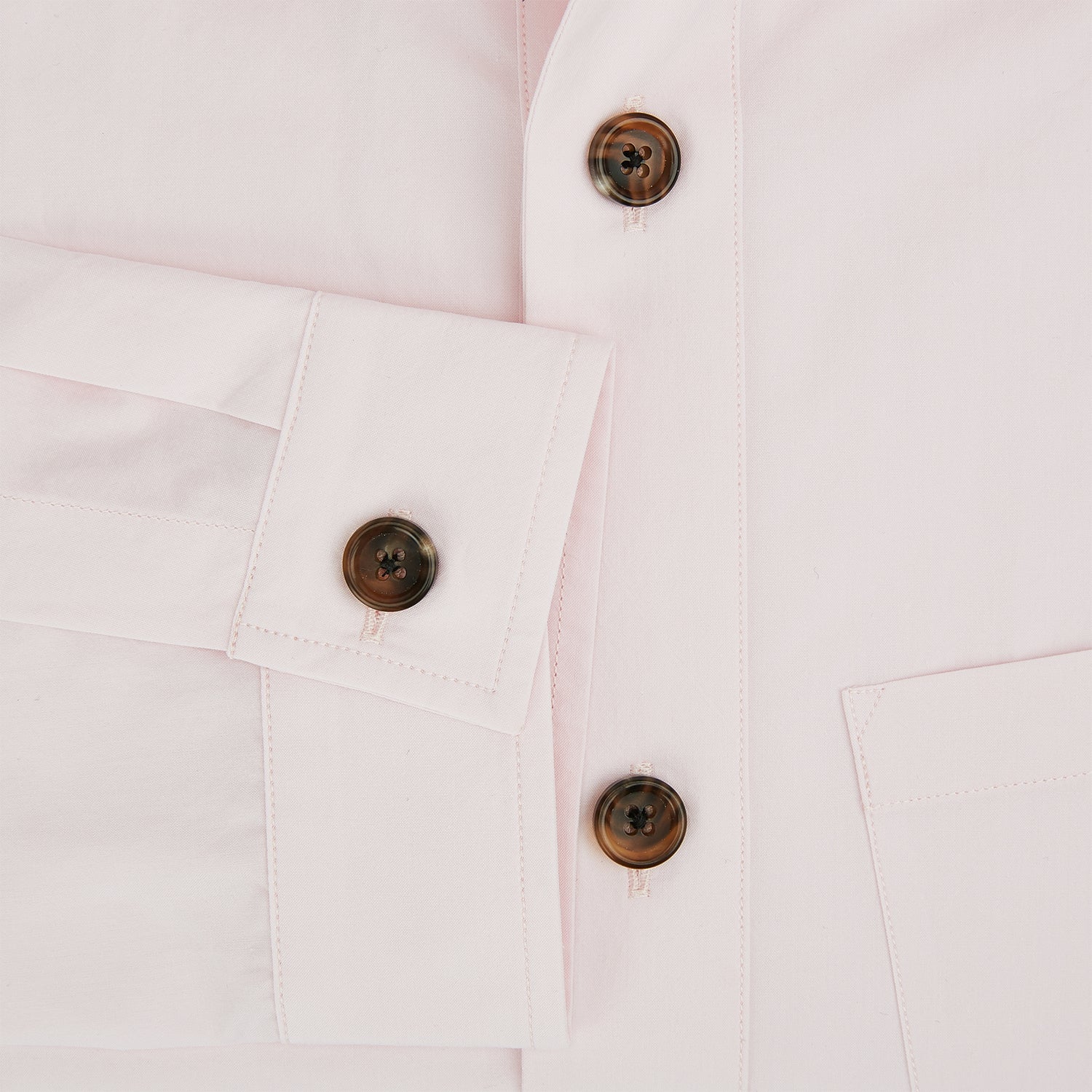 View 4 of product The Soft Pink Hyde Overshirt by Turnbull & Asser features long sleeves, sanforised cotton, dark buttons, and a left front pocket, shown laid flat on a white background.