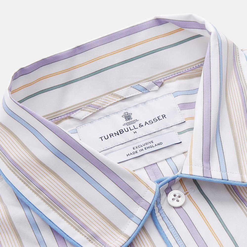 The Turnbull & Asser Colourful Garden Multi Stripe Cotton Sussex Nightshirt is UK-made, featuring vibrant stripes on white for timeless style and luxurious sleepwear comfort.