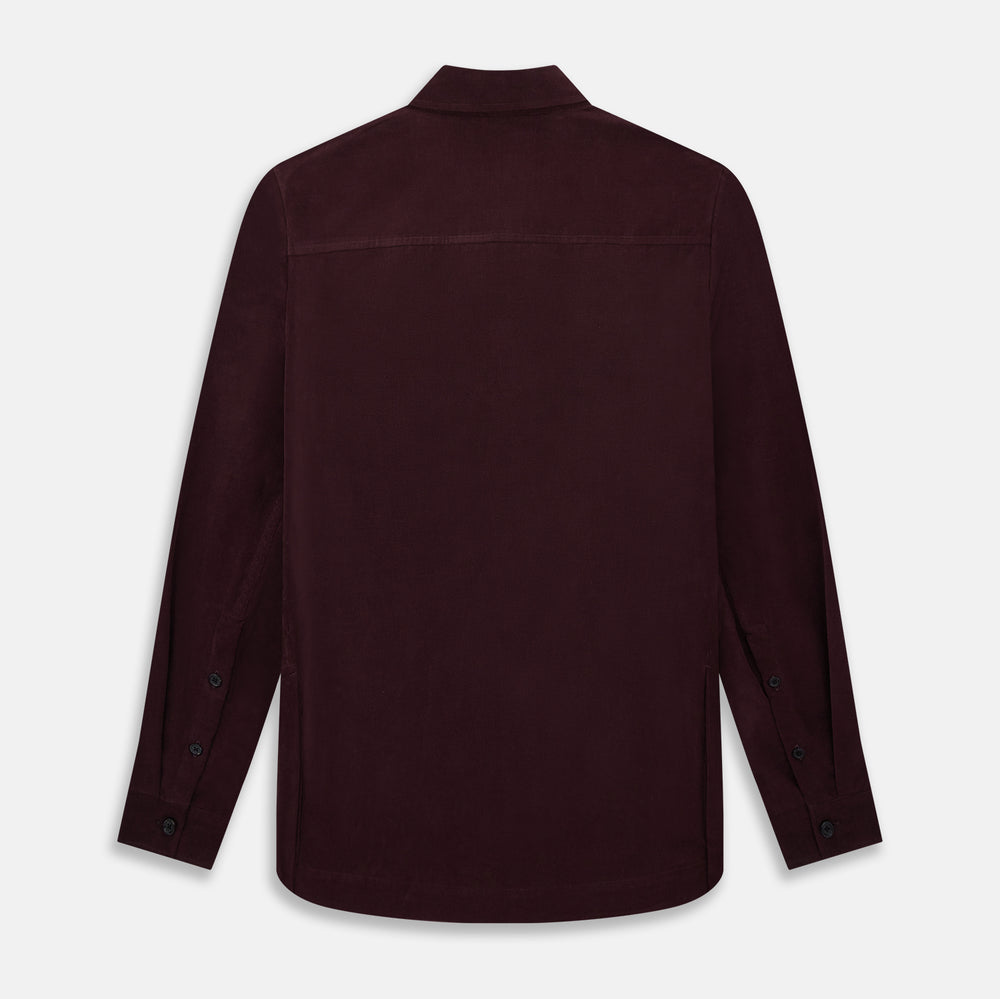 The Turnbull & Asser Burgundy Corduroy Hampstead Overshirt features long sleeves, a collar, a large left chest pocket, and two zippered side pockets, shown laid flat on a plain white background.