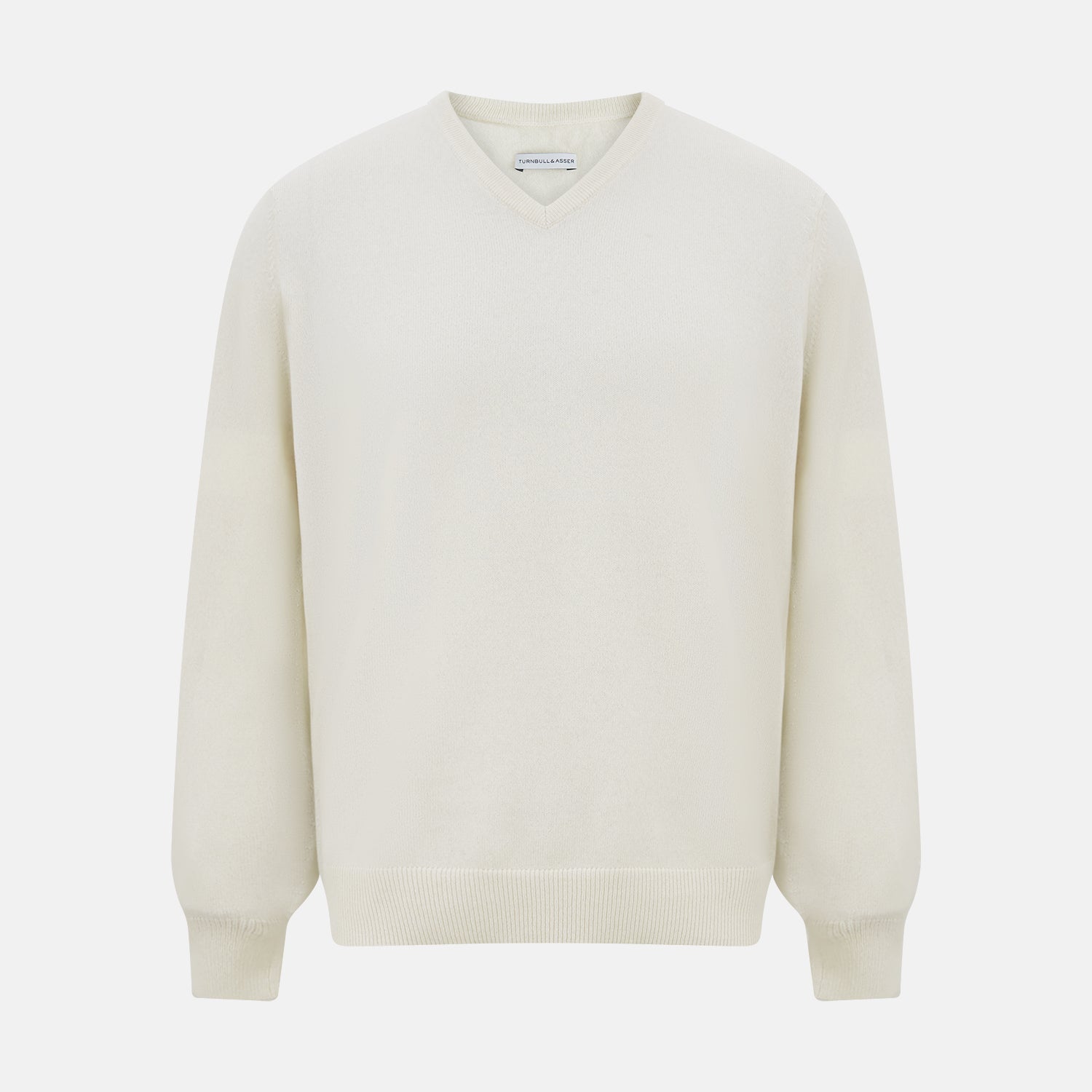 View 1 of product The Turnbull & Asser White Cashmere V-Neck Jumper features long sleeves and a versatile light cream shade, making it a timeless addition to your knitwear collection.