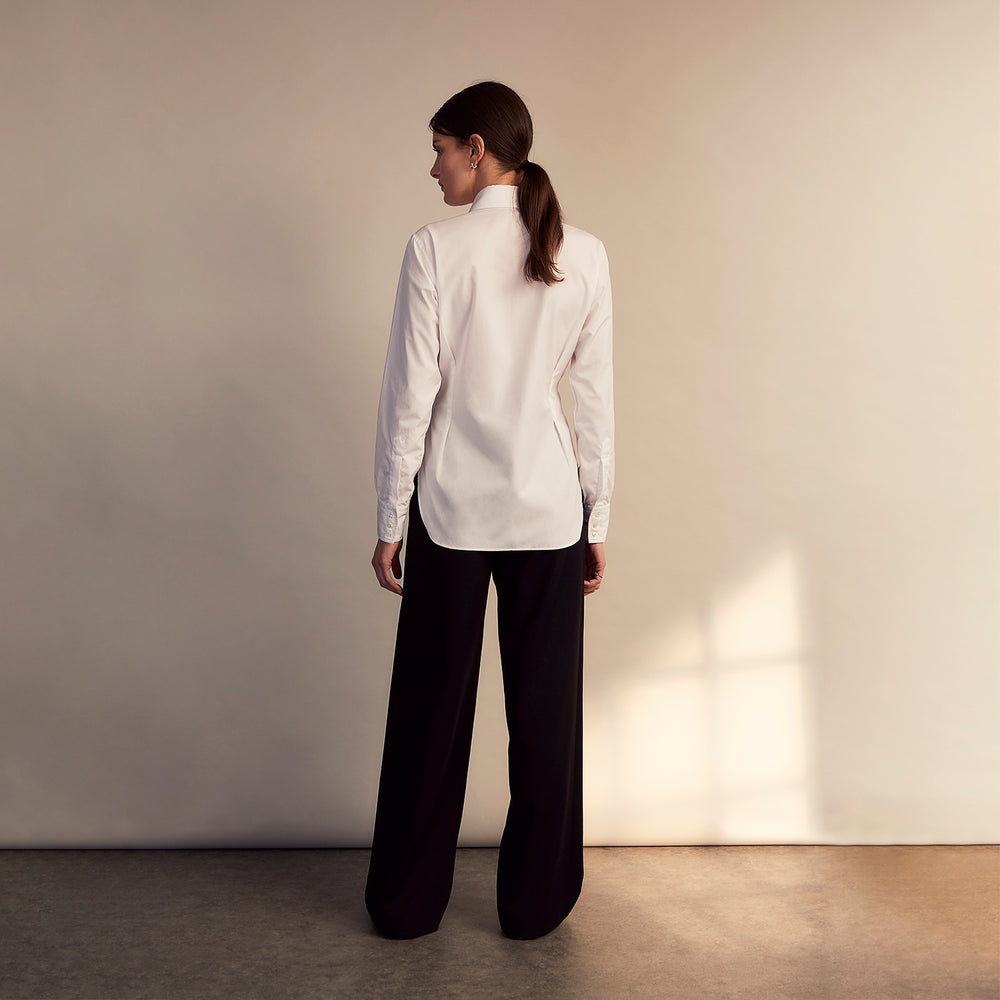 The White Cotton Tailored Bianca Shirt by Turnbull & Asser features a pointed collar and button cuffs, crafted from soft organic cotton and displayed flat on a white background for timeless elegance.