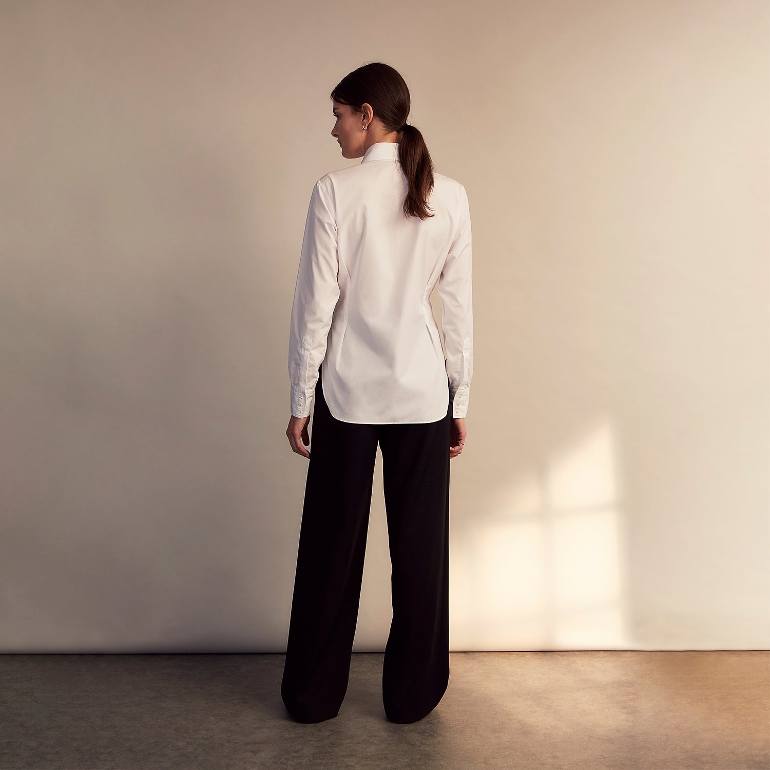 View 6 of product The White Cotton Tailored Bianca Shirt by Turnbull & Asser features a pointed collar and button cuffs, crafted from soft organic cotton and displayed flat on a white background for timeless elegance.