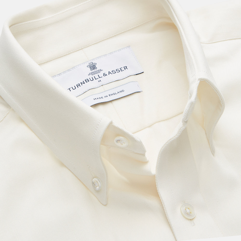 The Turnbull & Asser Cream Weekend Fit Hayne Shirt features a Dorset collar and 1-button cuffs, displayed long-sleeved and laid flat on a white background.