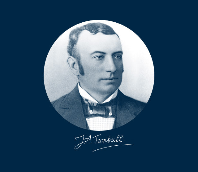 A vintage portrait of a man in a suit and bow tie, set against a blue background. A signature reading J.A. Turnbull appears below the portrait in white script.