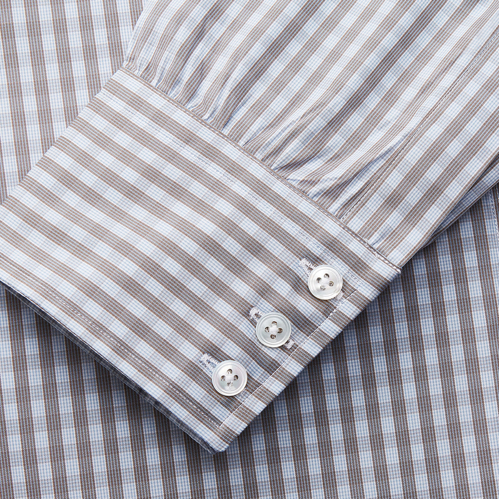 The Turnbull & Asser Pale Blue Multi Check Cotton Regular Fit Mayfair Shirt features a pale blue checkered pattern and long sleeves, shown on a white background.