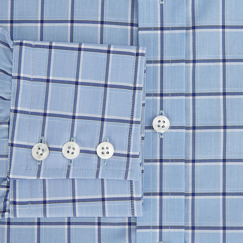 The Turnbull & Asser Blue and Navy Windowpane Mayfair Shirt features long sleeves, a T&A collar, buttoned cuffs, and Italian cotton in a blue and navy windowpane pattern, shown on a plain white background.