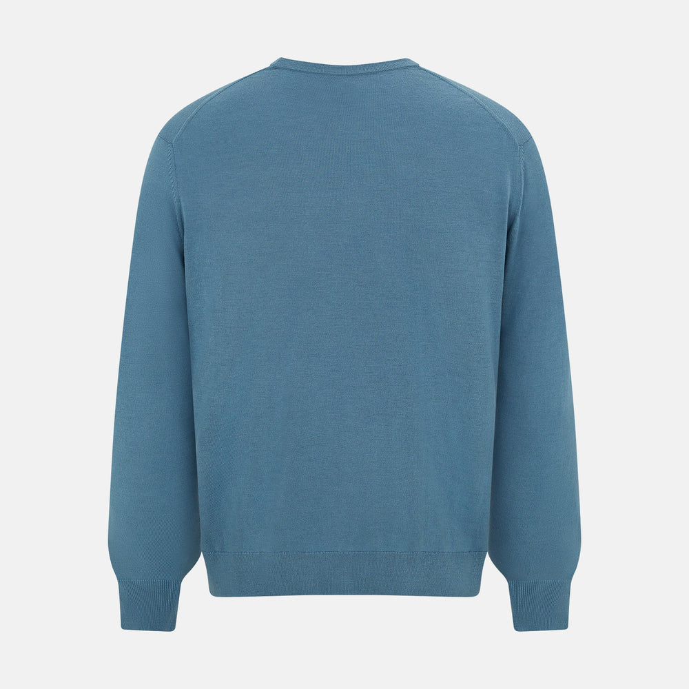 The Turnbull & Asser Pale Blue Fine Merino V-Neck Cardigan features long sleeves and five black buttons, showcased on a plain white background.