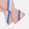 View 3 of product The Thistle-Petersham-Double End Bow Tie by Turnbull & Asser features a pink base with diagonal blue, white, and navy stripes—a versatile accessory perfect for any gentleman's wardrobe.