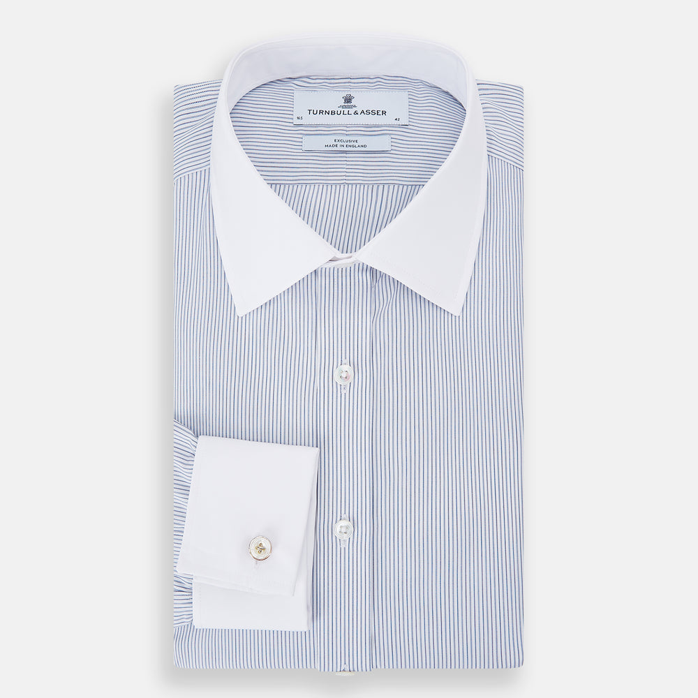 The Turnbull & Asser Navy and Blue Ticking Stripe Shirt features a contrast white collar and double cuffs, displayed on a plain white background. Tailored in the sleek Mayfair fit, it’s ideal for formal attire.