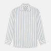 View 2 of product A man with short brown hair stands against a beige background in a Turnbull & Asser Blue and Off-White Stripe Cotton Weekend Fit Finch Shirt, featuring vertical stripes and a Derby collar, paired with dark pants. One hand is in his pocket; he has a neutral expression.