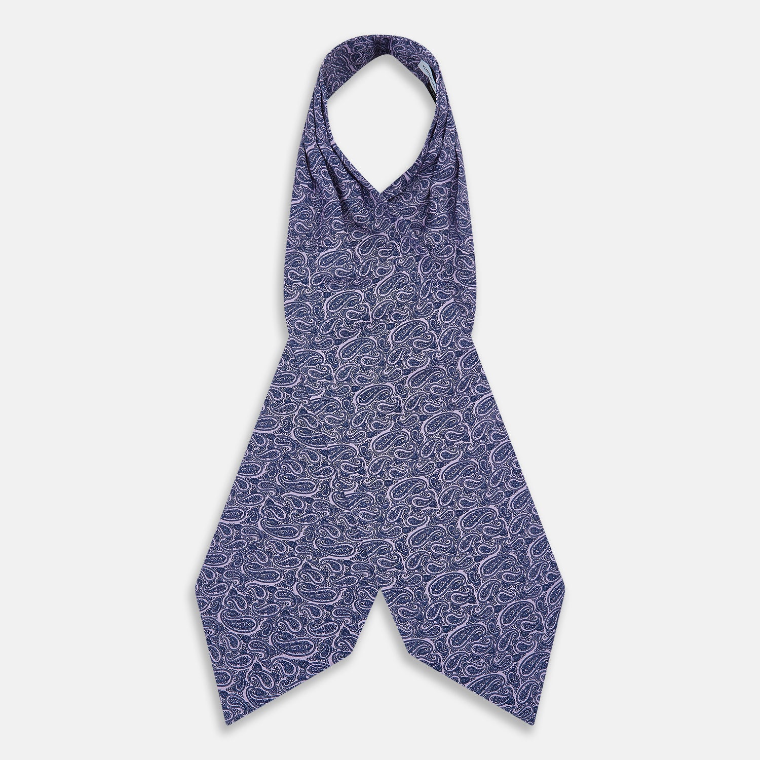 View 2 of product The Turnbull & Asser Lilac Paisley Silk Cravat showcases British elegance with its dark blue paisley pattern on a lilac background, beautifully displayed on a white surface.
