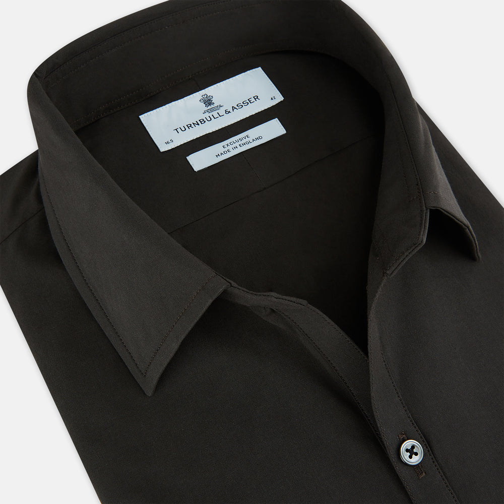 A brown Windsor long-sleeve button-up shirt by Turnbull & Asser with a classic collar, buttoned cuffs, and a straight hem, laid flat on a white background—showcasing refined British craftsmanship.