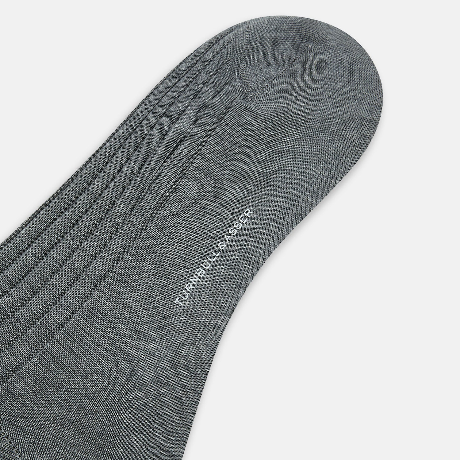 View 4 of product The Ash Mid-Length Sock by Turnbull & Asser, shown upright on a plain white background, is a single dark gray ribbed knee-high made from mercerised Egyptian cotton.