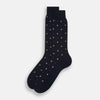 View 2 of product The Turnbull & Asser Midnight Patterned Mid-Length Sock features a ribbed cuff and a design of small white hexagons with red dots, shown here as a single sock on a plain white background.