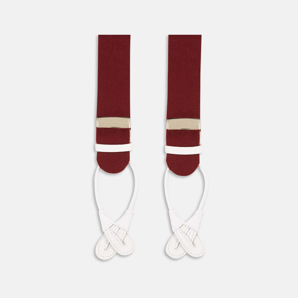 A pair of Turnbull & Asser Bordeaux Adjustable Felt Braces, featuring white leather ends and gold metal adjusters, made in England, are displayed vertically on a plain white background.