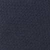View 4 of product The Turnbull & Asser Plain Woven Grenadine Silk Tie in navy, with a textured finish, is rolled and displayed on a white background—a refined essential for any wardrobe.