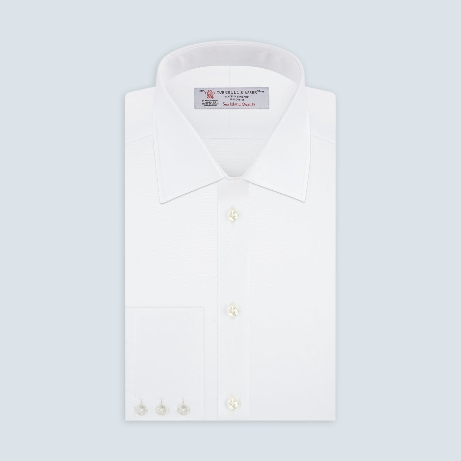 View 1 of product The Turnbull & Asser White Self-On-Self Herringbone Sea Island Quality Cotton Shirt features a T&A collar, 3-button cuffs, and luxurious Egyptian cotton, displayed neatly folded against a light gray background.