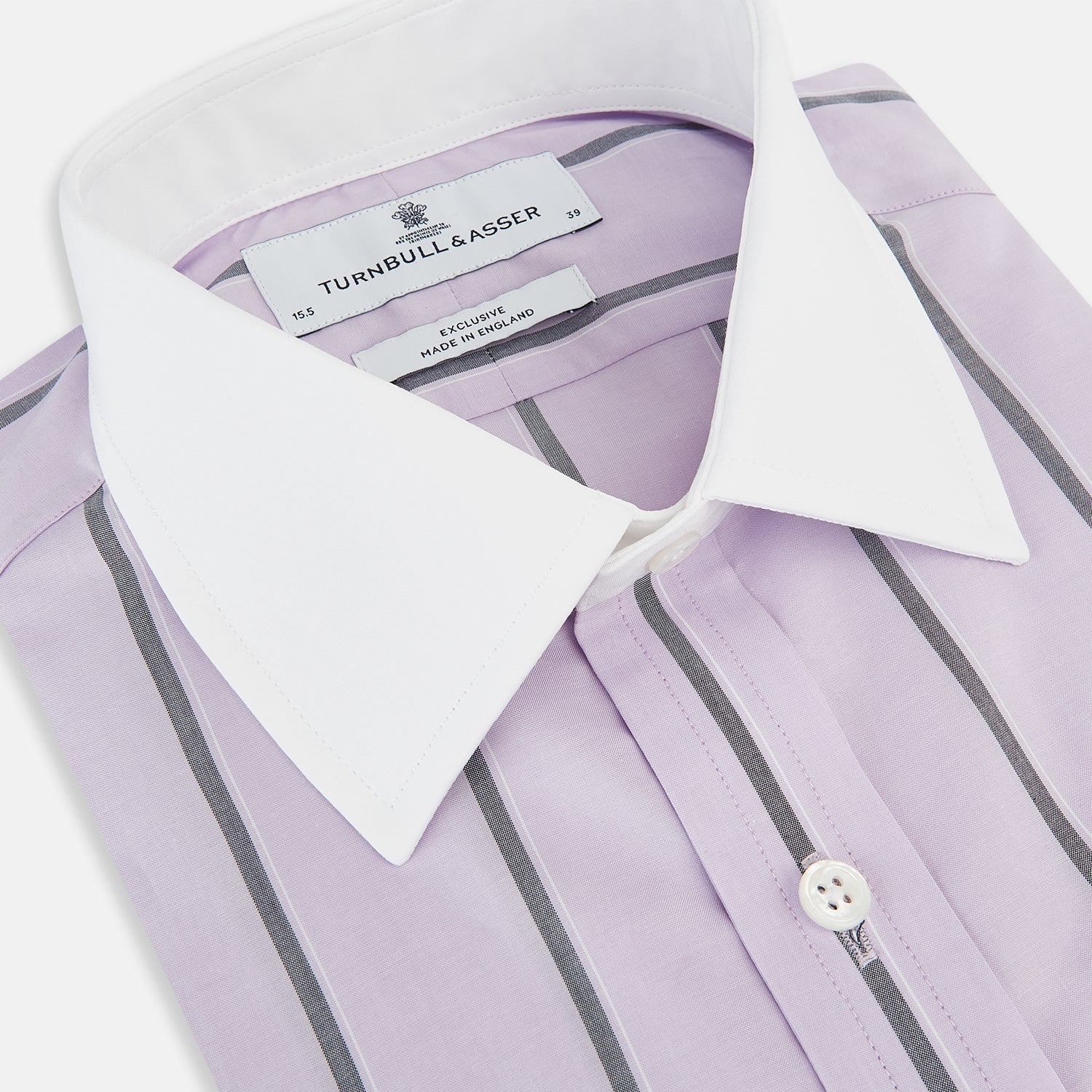 View 2 of product The Turnbull & Asser Lilac Track Stripe Shirt with Contrast T&A Collar and Cuffs features vertical black stripes, a white pointed collar, and white cuffs, shown flat against a white background.