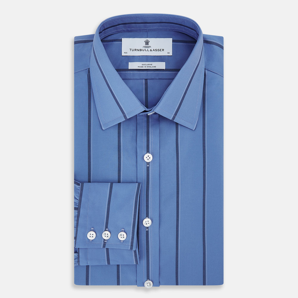 The Turnbull & Asser Colony Blue Track Stripe Mayfair Shirt is crafted from Italian cotton with long sleeves, dark blue track stripes, a classic collar, and buttoned cuffs, shown against a white background.