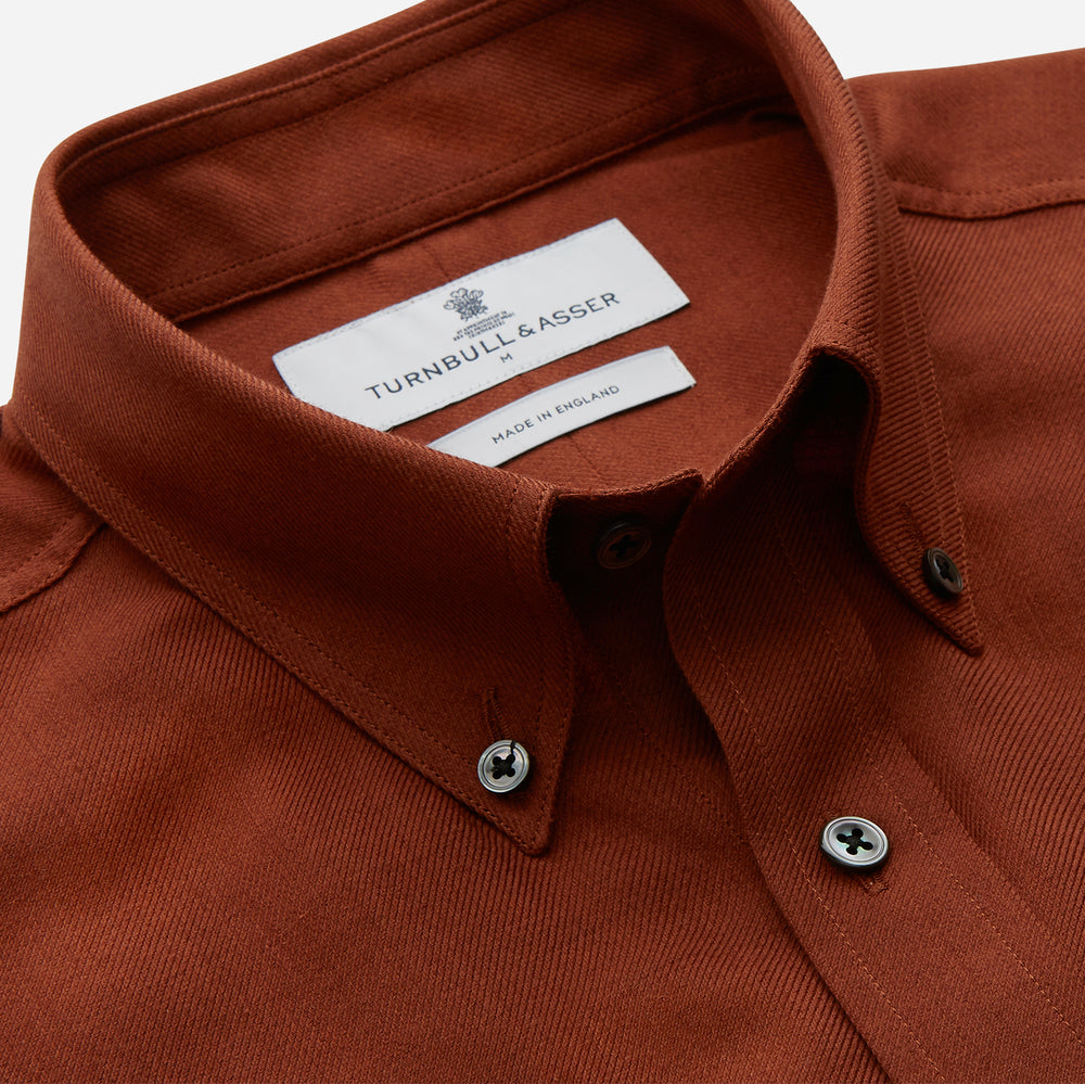 The Turnbull & Asser Burgundy Cotton and Cashmere Weekend Fit Shirt features a Dorset collar, 1-button cuffs, and a relaxed fit, shown flat against a white background.