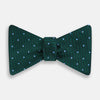 View 1 of product The Turnbull & Asser Forest Green and Sky Blue Spot Houndstooth Silk Bow Tie features a textured pattern with light blue polka dots, shown against a plain white background.
