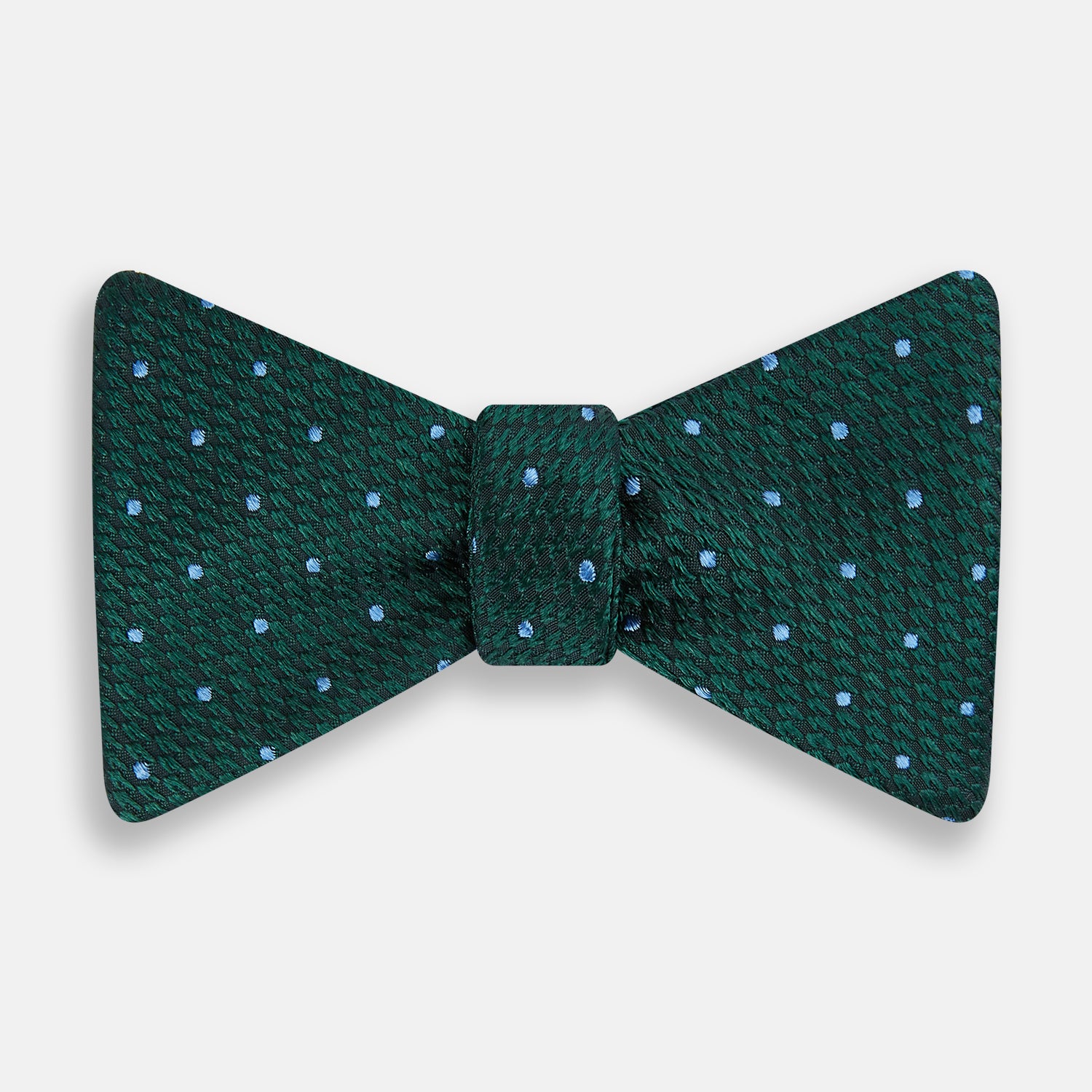 View 1 of product The Turnbull & Asser Forest Green and Sky Blue Spot Houndstooth Silk Bow Tie features a textured pattern with light blue polka dots, shown against a plain white background.