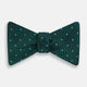 The Turnbull & Asser Forest Green and Sky Blue Spot Houndstooth Silk Bow Tie features a textured pattern with light blue polka dots, shown against a plain white background.
