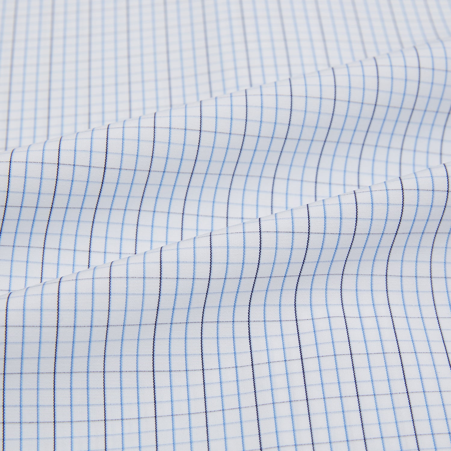 View 6 of product The Turnbull & Asser Pale Blue and Navy Grid Check Mayfair Shirt is a long-sleeve, button-up shirt made from fine Italian cotton, featuring a pointed collar and buttoned cuffs, shown against a plain white background.