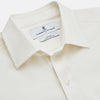 View 3 of product The Turnbull & Asser Cream Silk Weekend Fit Fairlight Shirt is a classic, soft-touch long-sleeve shirt with a collar, button-down front, and buttoned cuffs, shown laid flat on a plain white background.