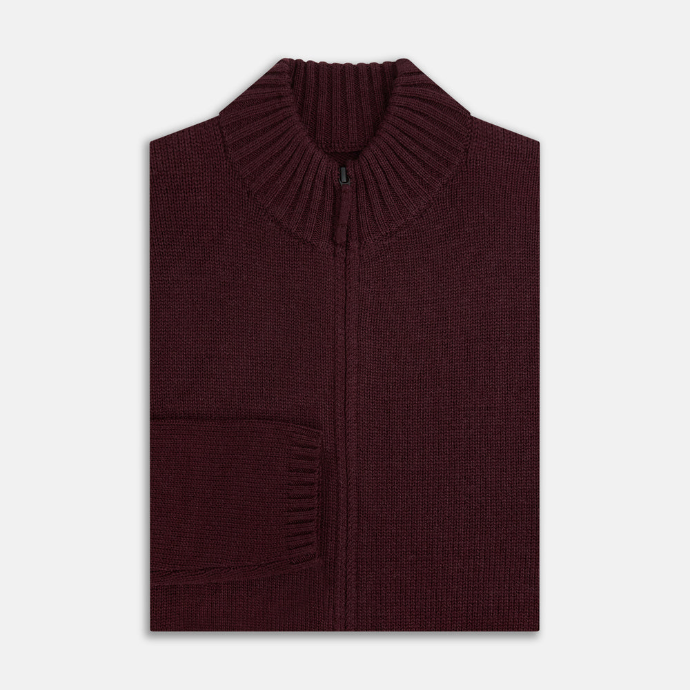 The Turnbull & Asser Burgundy Merino High Neck Zipped Cardigan features long sleeves, a zip-up front, and ribbed collar, cuffs, and hem, crafted from soft merino knitwear and shown on a white background.