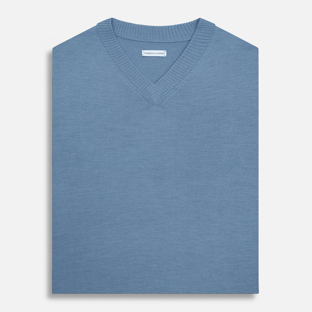 The Turnbull & Asser Pale Blue Fine Merino V-Neck Vest features a sleeveless design, knit texture, and classic V-neckline, shown against a plain white background.