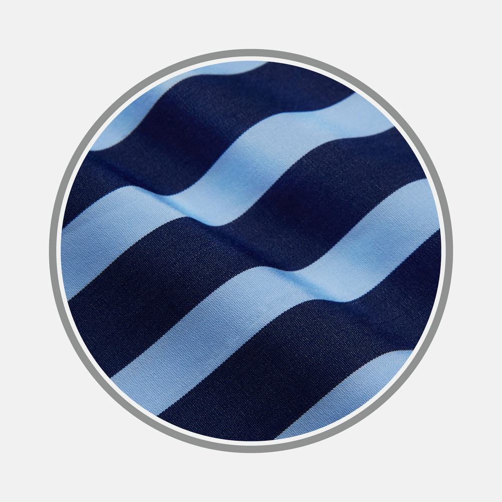 Close-up of Turnbull & Asser’s Navy Wide Stripe Cotton Fabric, showing textured, slightly wavy horizontal stripes in light and dark blue through a circular frame.