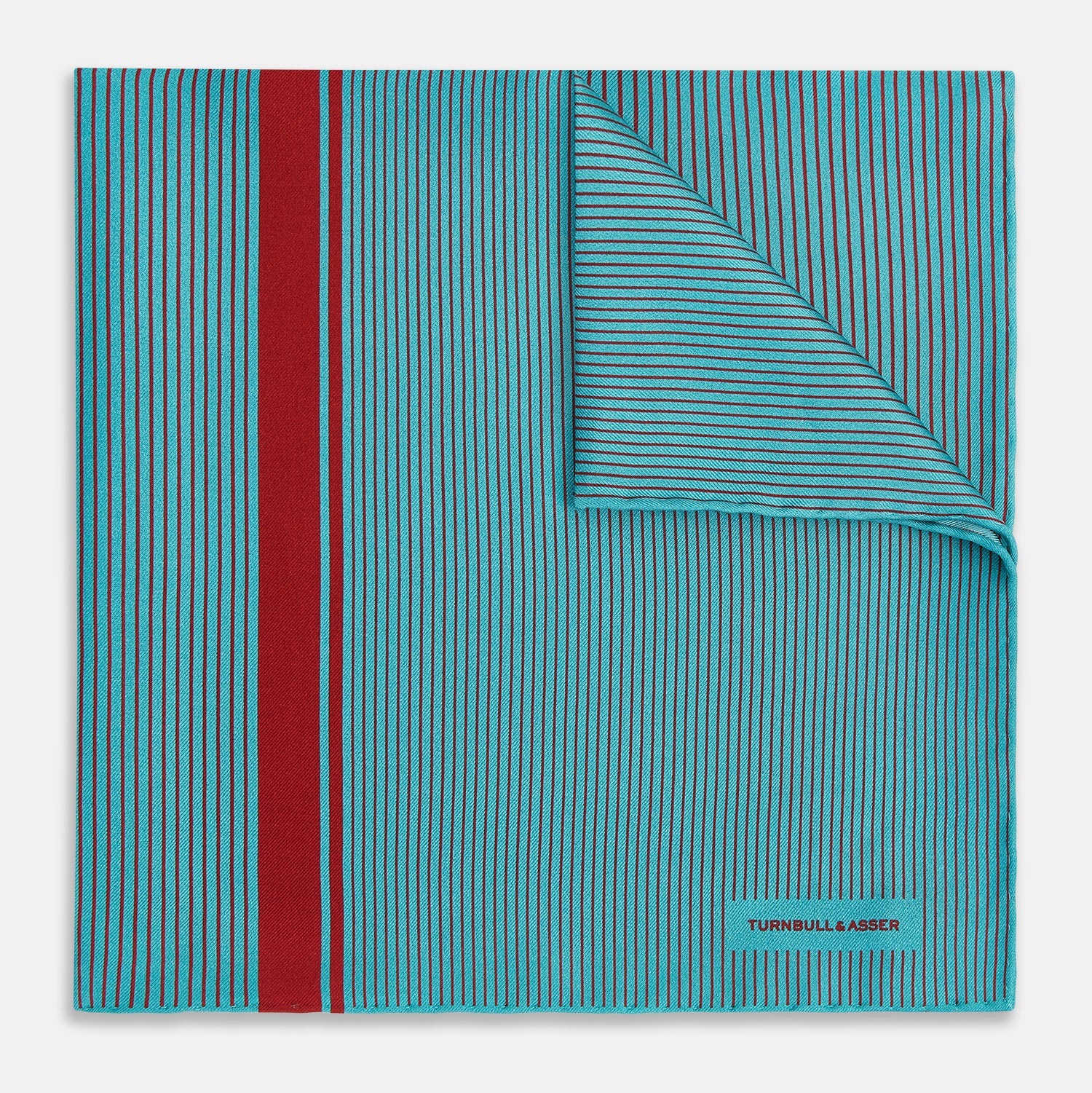 View 1 of product The Turnbull & Asser Turquoise and Red Stripe Silk Pocket Square features thin navy stripes with a bold vertical red stripe, partially folded to reveal the reverse pattern and the brand's logo, showcasing its British heritage.