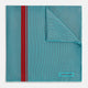 The Turnbull & Asser Turquoise and Red Stripe Silk Pocket Square features thin navy stripes with a bold vertical red stripe, partially folded to reveal the reverse pattern and the brand's logo, showcasing its British heritage.
